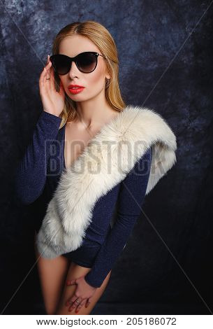 Stylish blonde in arctic fox and sun glasses.