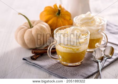 Pumpkin latte hot caffee drink with pumpkins whipped cream and spices
