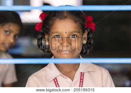 PONDICHERY PUDUCHERY INDIA - SEPTEMBER 04 2017. Unidentified child at schhol behind the window