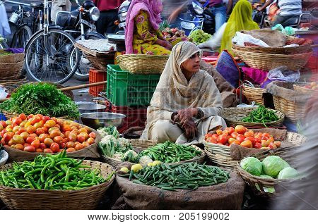 UDAJPUR INDIA - 28 FEBRUARY 2010: Indian Colorfully women seling the vegetables on the street in India