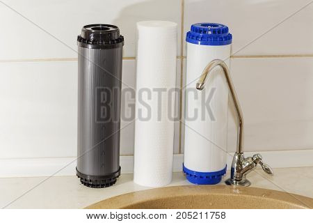 Great filters to purify your drinking water an image isolated in the kitchen interior.