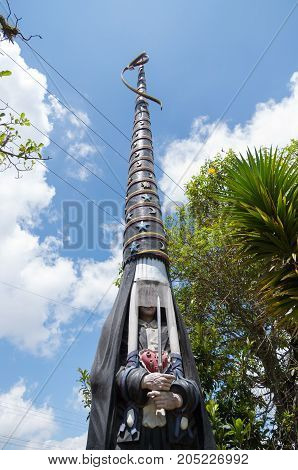 Quito, Ecuador - 28 APRIL, 2015 Stoned sculpture of a virgin with a huge hat in her head, with line cable over her, located in the valley of Los Chillos.