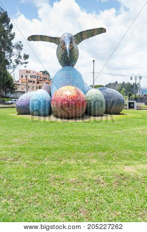 Quito, Ecuador - 28 APRIL, 2015 Historic monument of a huge colorful hummingbird sculpture located in the valley of Los Chillos.