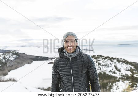 A Happy young man standing outdoors on winter mountain resort