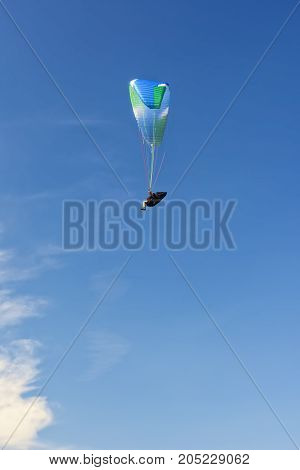 Skydiver in the clouds. Bright sports background