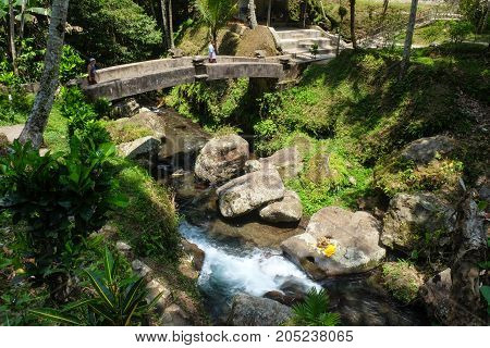 Stone bridge across river at Ganung Kawi Temple Bali Indonesia
