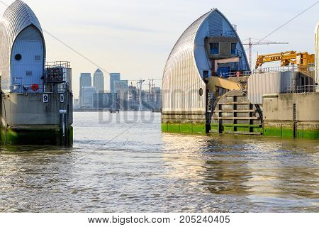 Thames Barrier With Canary Wharf In The Background