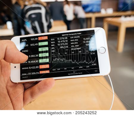 PARIS FRANCE - SEP 22 2017: New iPhone 8 and iPhone 8 Plus as well the updated Apple Watch Apple TV goes on sale today in Apple Store with customer looking at standard and poor's composite index