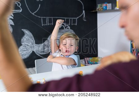 Cute little playfull toddler boy at child therapy session. Private one on one homeschooling with didactic aids.