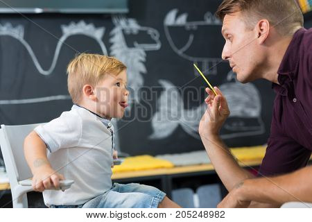 Cute little boy at speech therapist session. Private one on one homeschooling.