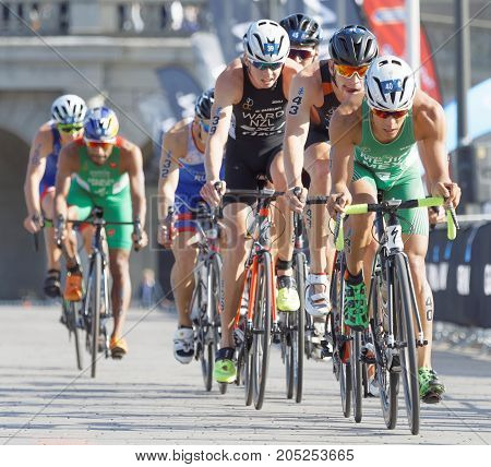 STOCKHOLM - AUG 26 2017: Back of group of colorful triathlete cyclists in the Men's ITU World Triathlon series event August 26 2017 in Stockholm Sweden
