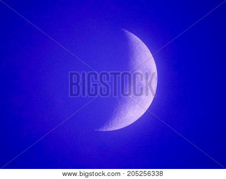 Photo of moon phase catching craters on it's surface