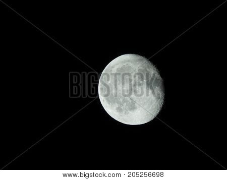 Photo of moon phase catching craters on it's surface
