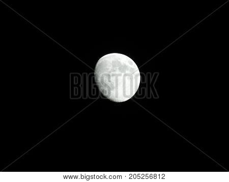 Photo of moon phase catching craters on it's surface