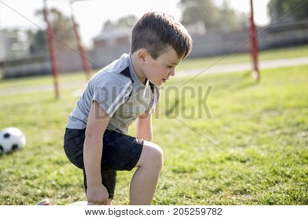 A Young caucassian soccer player football outside
