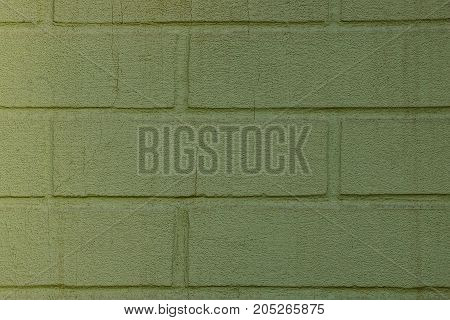 green texture of a fragment of brickwork on the wall of the house