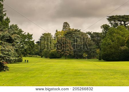 Warwick, United Kingdom - September 19, 2016: View of the Medieval castle tower and gatehouse from within the castle gardens and people enjoying the setting, Warwick, Warwickshire