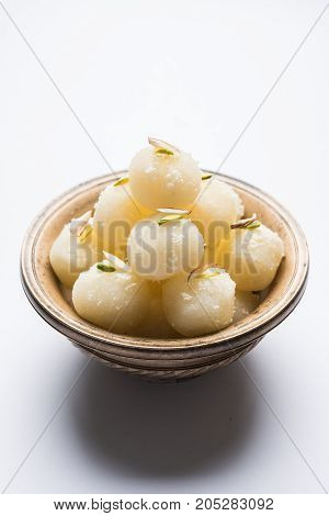 Stock Photo of Rasgulla or sponge Ras Gulla, It is made from ball shaped dumplings of chhena and semolina dough, cooked in light syrup made of sugar.