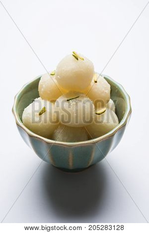 Stock Photo of Rasgulla or sponge Ras Gulla, It is made from ball shaped dumplings of chhena and semolina dough, cooked in light syrup made of sugar.