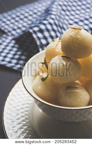 Stock Photo of Rasgulla or sponge Ras Gulla, It is made from ball shaped dumplings of chhena and semolina dough, cooked in light syrup made of sugar.