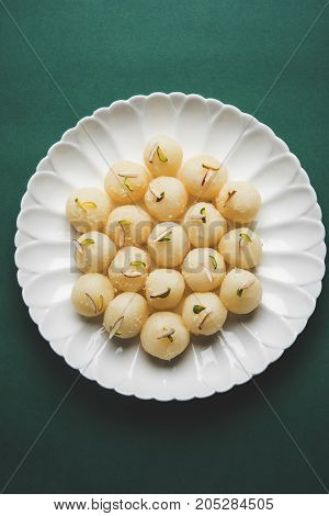 Stock Photo of Rasgulla or sponge Ras Gulla, It is made from ball shaped dumplings of chhena and semolina dough, cooked in light syrup made of sugar.