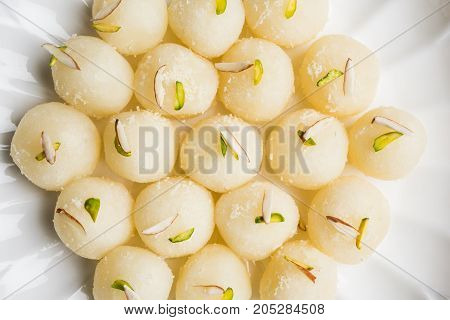 Stock Photo of Rasgulla or sponge Ras Gulla, It is made from ball shaped dumplings of chhena and semolina dough, cooked in light syrup made of sugar.