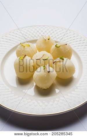 Stock Photo of Rasgulla or sponge Ras Gulla, It is made from ball shaped dumplings of chhena and semolina dough, cooked in light syrup made of sugar.