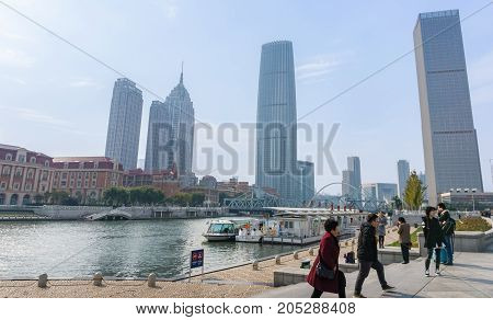 Tianjin, China - Nov 1, 2016: Commercial skyline across the Haihe River. Buildings in contrasting modern and old architectural style.