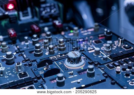 Detailed view of the upper set of switches in a large airliner. Selective focus. Low Light from a plane control cockpit in the dark vintage detail on the interior cockpit