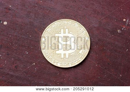 Golden bitcoin on red background, close up. High resolution photo.