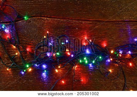 Christmas rustic background - vintage planked wood with lights and free text space.