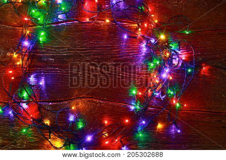 Christmas rustic background - vintage planked wood with lights and free text space.