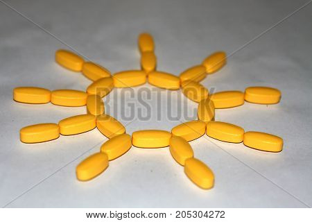 Tablets and capsules are lined in the form of the sun.