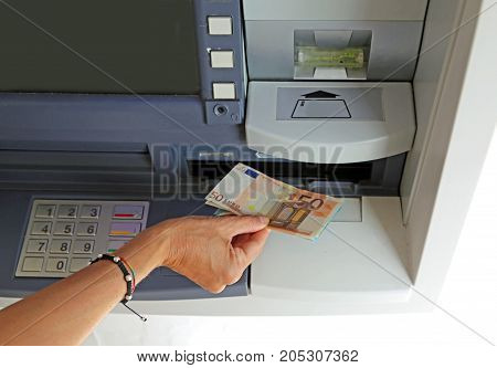 Hand Of Young Woman While Withdrawing Banknotes 50 Euros From An