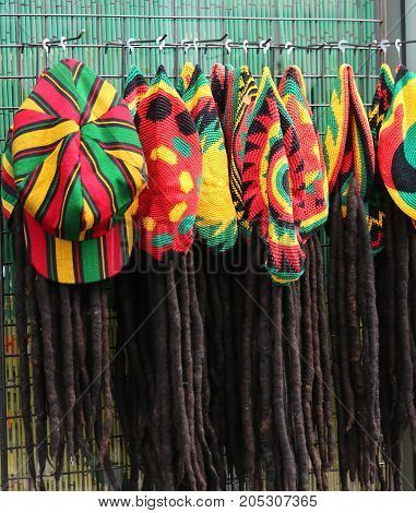 many hats with the colors of the Jamaican flag for sale in the costume shop