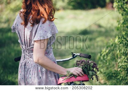 Vitage girl ride on bicycle with flowers spring and summer