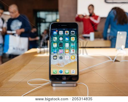 PARIS FRANCE - SEP 22 2017: New iPhone 8 and iPhone 8 Plus in Apple Store with home screen desktop apps and customers in the background