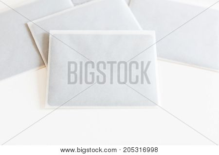 party, creating, wedding concept. there are dark black cards in few little white envelopes for inviting guest for celebration made of transparent rice paper on the workdesk