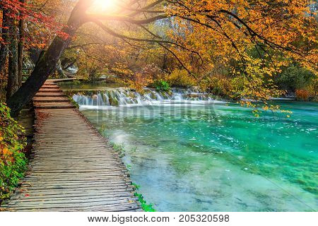 Stunning touristic wooden pathway in the colorful deep forest with clean lakes and spectacular waterfalls Plitvice National Park Croatia Europe