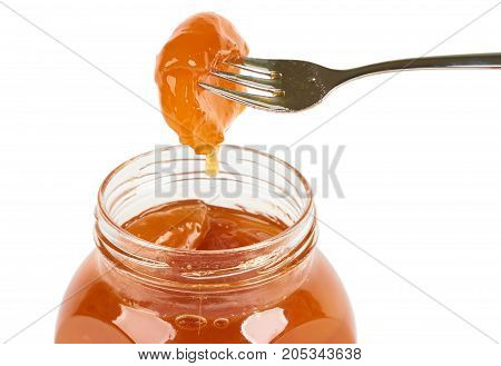 One hulf of apricot on the fork from apricot jam