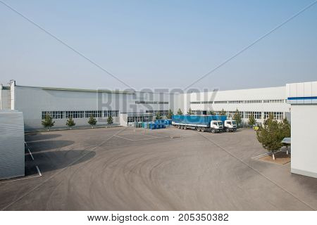 general view of the factory with trucks. a truck in the parking lot of the plant
