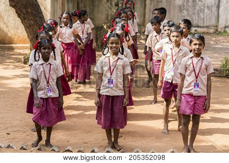 PONDICHERY PUDUCHERY INDIA - SSEPTEMBER 04 2017. School parade of each monday morning with children students in uniforms. They walk sing and pray before going in the classrooms.