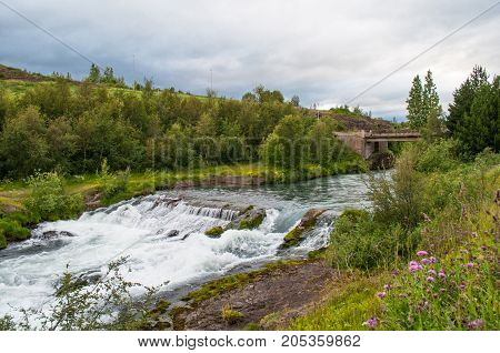 an old dam from the industrial era in Glera river in North Iceland