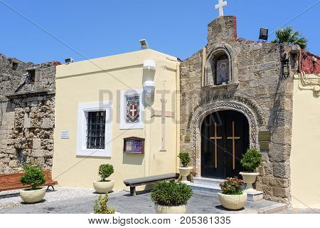 Small Greek church mounted in wall of old fortress in Rhodes town on Rhodes island