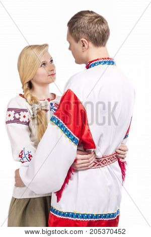 Portrait of Loving Embraced Caucasian Couple in National Belarussian and Russian Decorated Costumes. Against White Background. Vertical Image Orientation