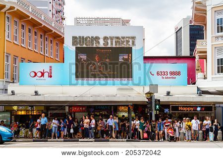 SINGAPORE - SEPTEMBER 7 2017: Shoppers waiting outside Bugis Street Market a bargain place renowned for cheap food; clothing souvenirs electronics houseware and cosmetics.