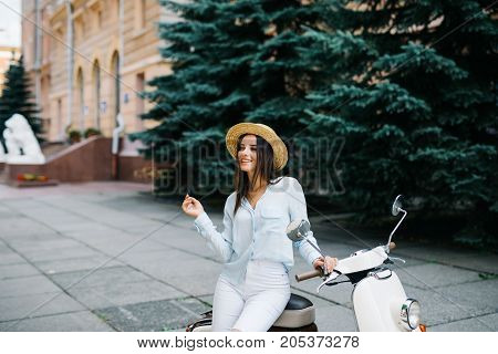 Young Beautiful Sexy Woman Sitting On A Scooter Outdoor