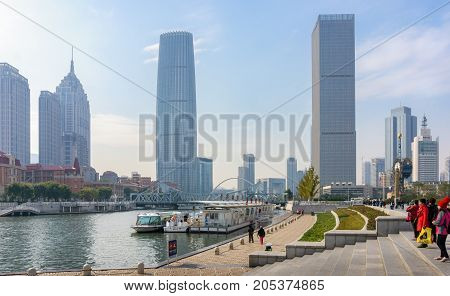 Tianjin, China - Nov 1, 2016: Commercial skyline across the Haihe River. Buildings in modern architectural style. Image includes the Century Clock (right).
