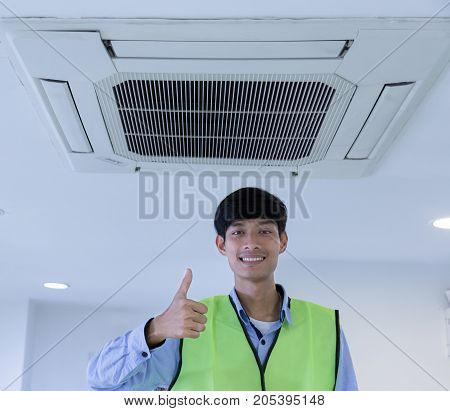 Technician repairing air conditioner on the wall