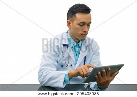 Asian young doctor using digital tablet computer for looking at patient information at clinic isolated on white background concept of medical technology innovation.